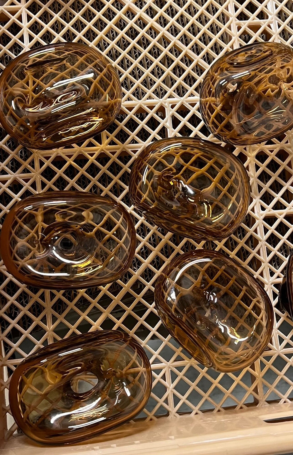 Pica Scent incense and amber glass holders on a studio table.